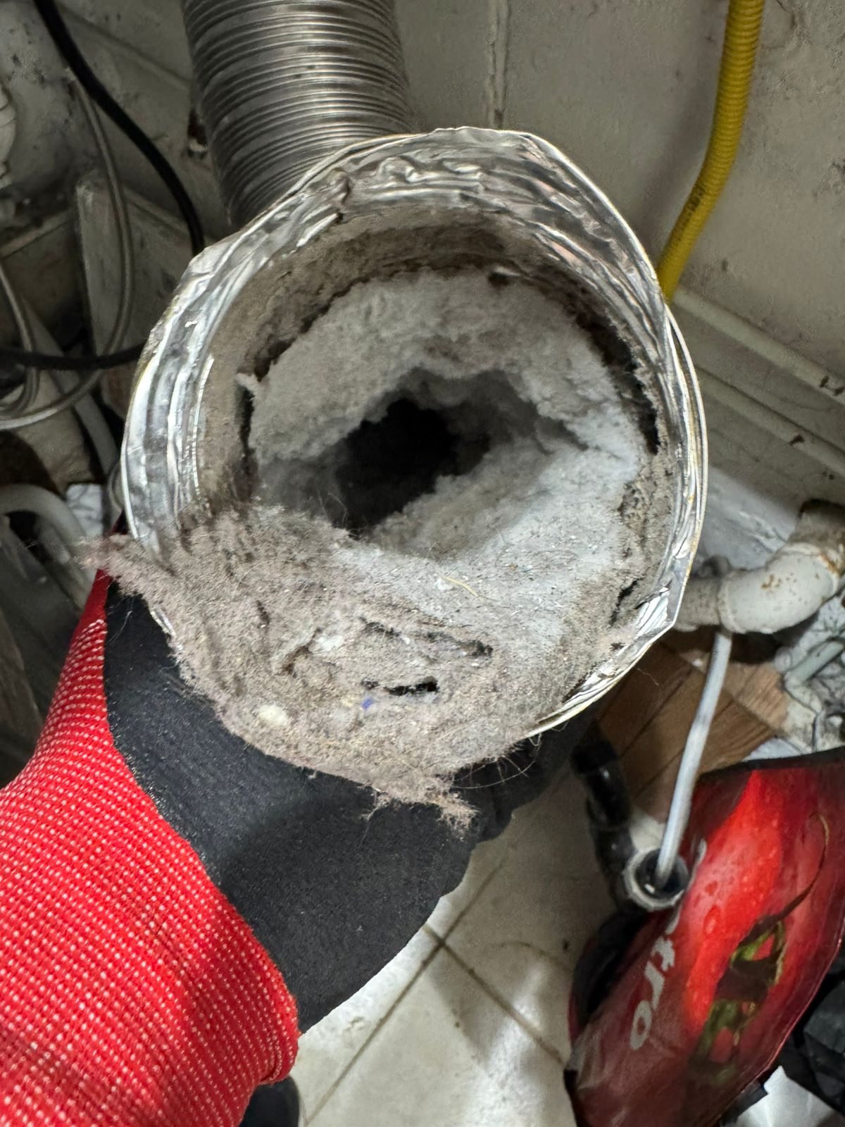 dryer vent inspection revealing lint accumulation inside wall