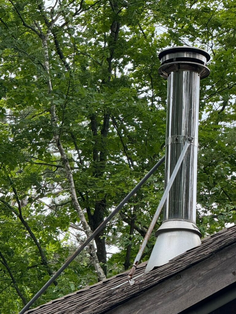 Factory-built stainless steel chimney system for wood stove — Ontario cottage WETT inspection